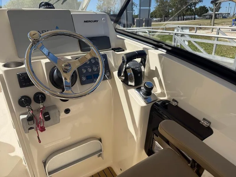 Slide: The Image of 2015 Scout 275 Dorado boat helm with Mercury controls and steering wheel. - 15