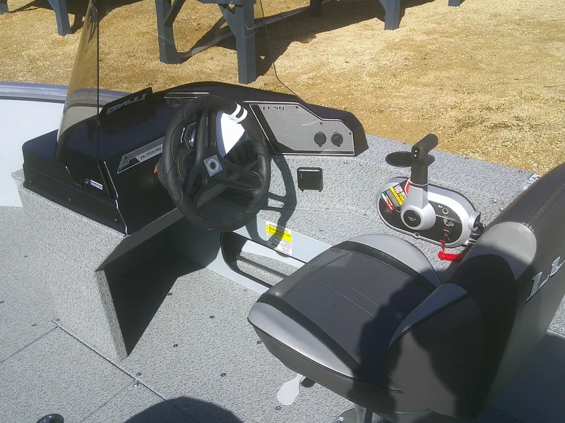 Slide: The Image of 2025 Lund 1675 Alaskan SS boat interior with steering wheel and control panel. - 10