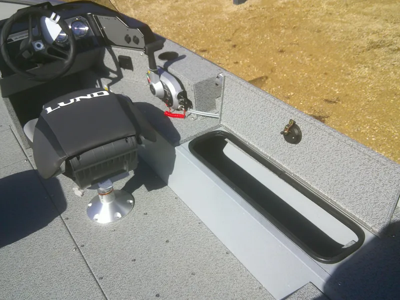 Slide: The Image of 2025 Lund 1675 Alaskan SS boat interior with steering wheel and seating. - 14