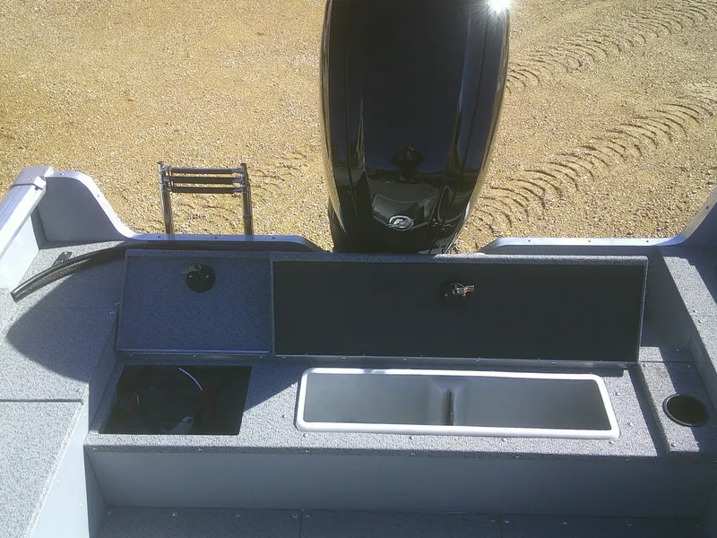 Slide: The Image of 2025 Lund 1675 Alaskan SS boat interior with motor and storage compartments. - 15