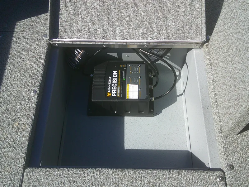 Slide: The Image of 2025 Lund 1675 Alaskan SS boat compartment with Minn Kota Precision charger. - 16