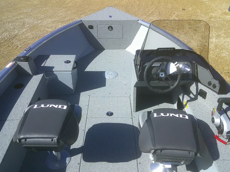 Slide: The Image of 2025 Lund 1675 Alaskan SS boat interior with two seats and steering console. - 4