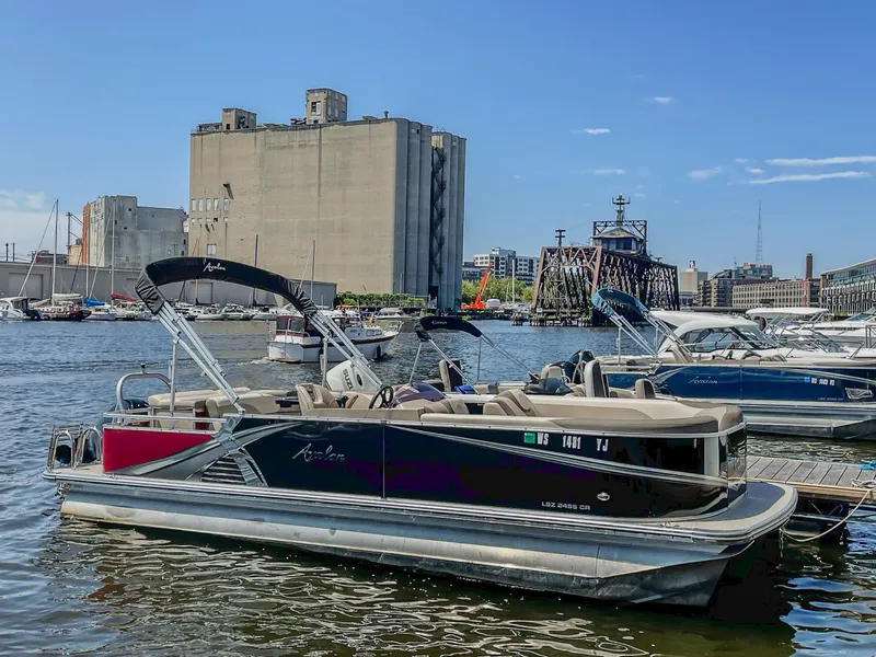 Slide: The Image of 2021 Avalon LSZ 2485 CR pontoon boat docked in urban marina setting. - 4