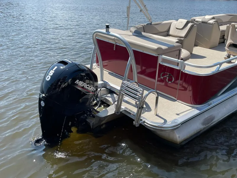Slide: The Image of 2021 Avalon LSZ 2485 CR pontoon boat with Mercury outboard motor on water. - 5