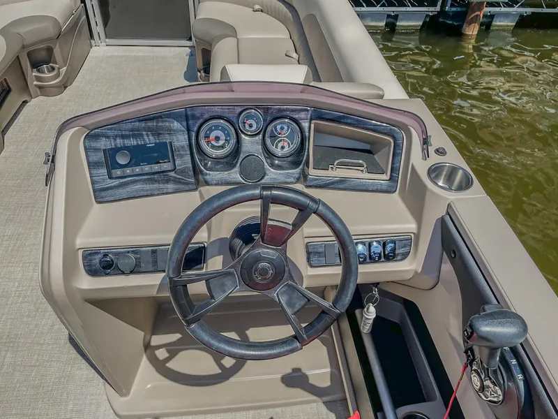 Slide: The Image of 2021 Avalon LSZ 2485 CR boat dashboard with steering wheel and control panel. - 7