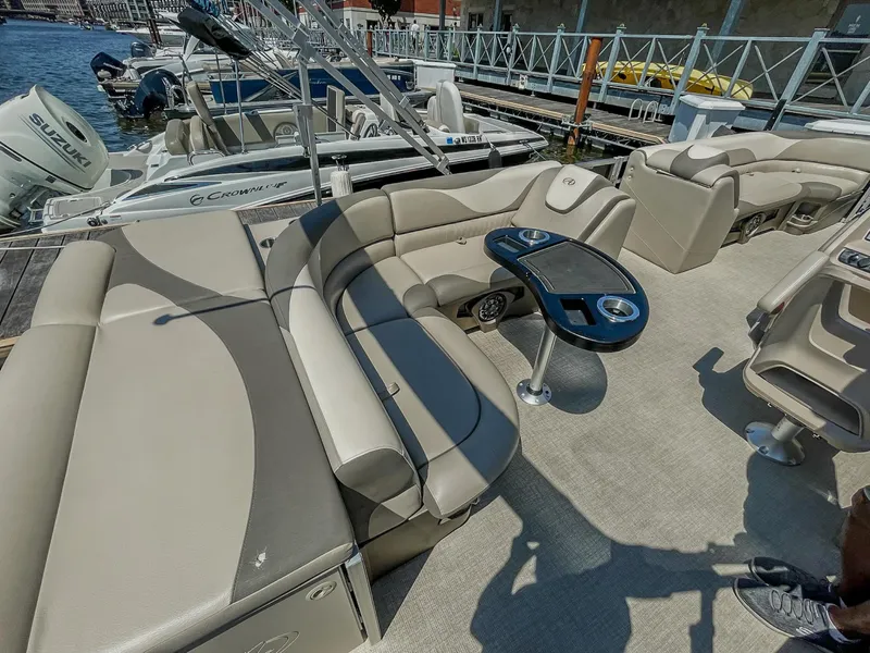 Slide: The Image of 2021 Avalon LSZ 2485 CR pontoon boat with beige seating and table, docked at marina. - 8