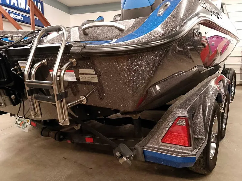 Slide: The Image of 2021 Ranger 622FS Pro boat, metallic finish, rear view with ladder and trailer. - 15