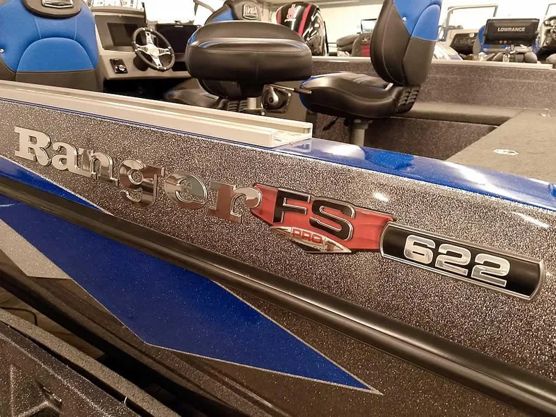 Slide: The Image of 2021 Ranger 622FS Pro boat interior with blue and black seating, steering wheel, and model branding. - 2