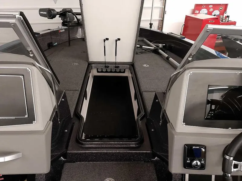 Slide: The Image of 2021 Ranger 622FS Pro boat interior with open storage compartment and dual consoles. - 20