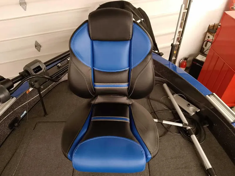 Slide: The Image of 2021 Ranger 622FS Pro boat seat, blue and black design, in a garage setting. - 26