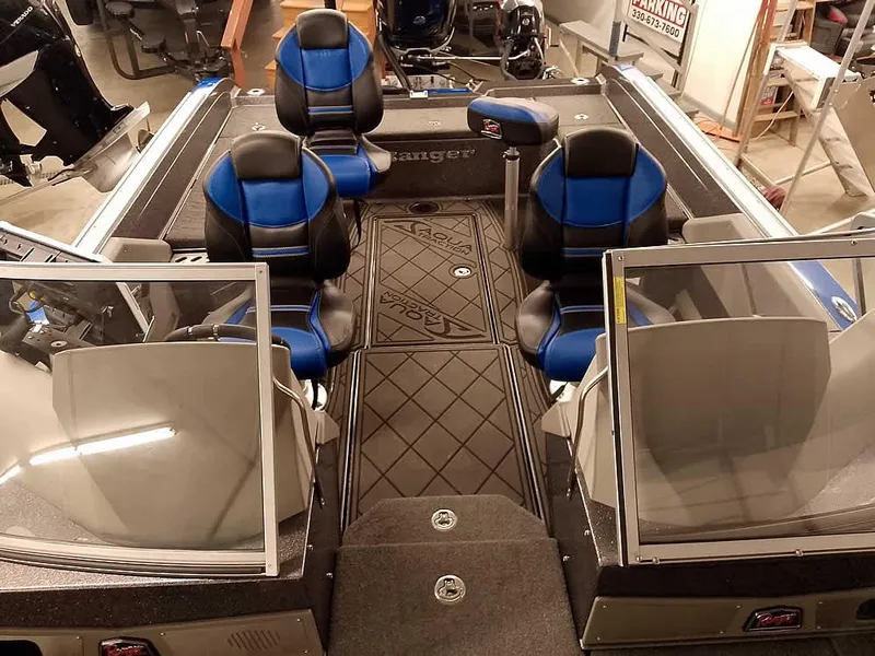 Slide: The Image of 2021 Ranger 622FS Pro boat interior with blue and black seating, dual windshields, and spacious layout. - 31