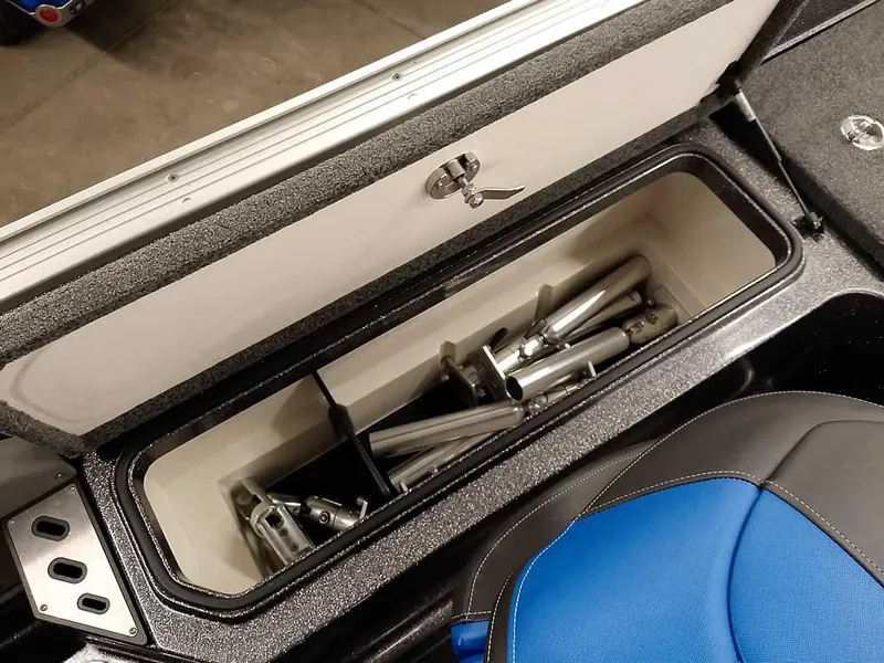 Slide: The Image of Storage compartment in a 2021 Ranger 622FS Pro boat, containing metal rods. - 42