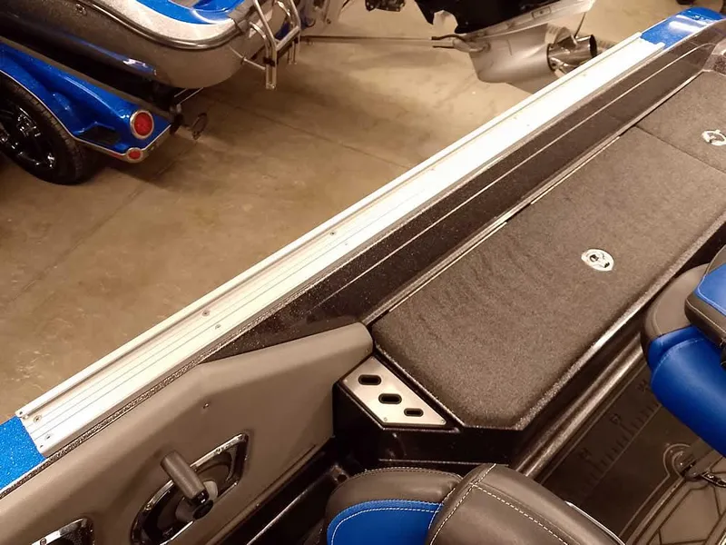 Slide: The Image of 2021 Ranger 622FS Pro boat interior with blue and black seating and storage compartments. - 43