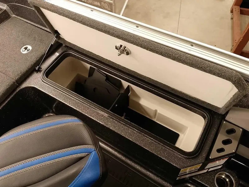 Slide: The Image of 2021 Ranger 622FS Pro boat storage compartment with blue-accented seat. - 44