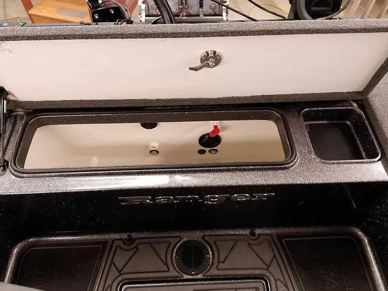 Slide: The Image of 2021 Ranger 622FS Pro boat storage compartment with lockable lid and interior view. - 47