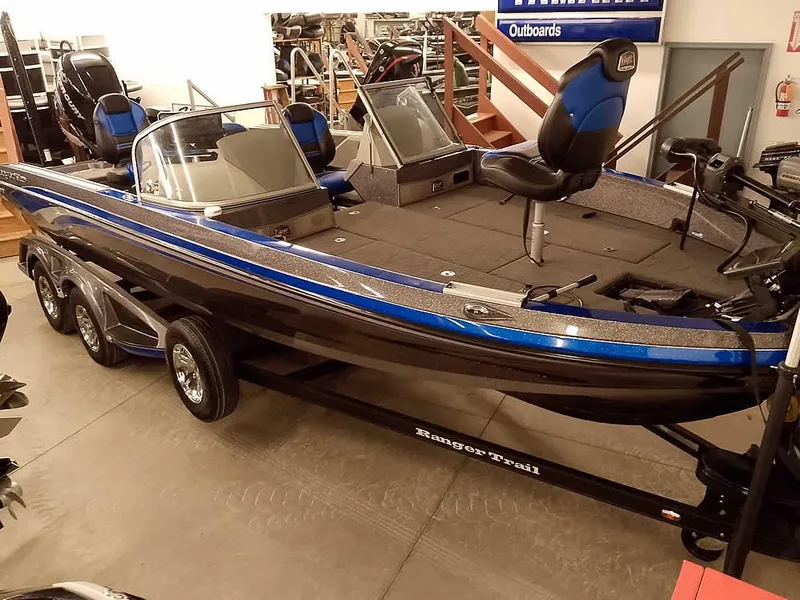 Slide: The Image of 2021 Ranger 622FS Pro boat with blue accents on a trailer in showroom. - 49