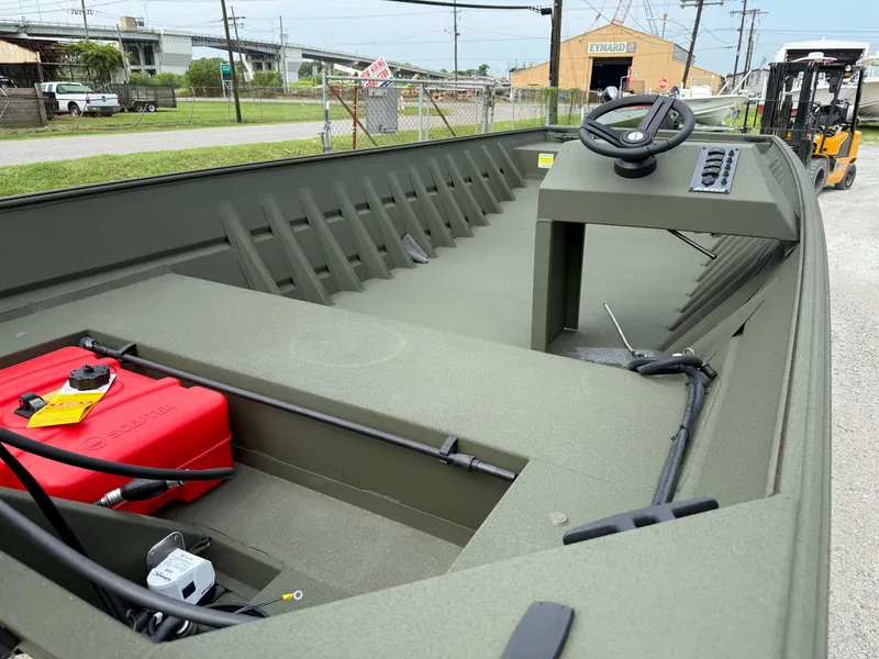 Slide: The Image of 2025 Alweld 1860 SC FLAT boat interior with steering console and red fuel tank. - 1