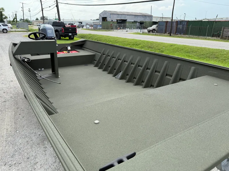 Slide: The Image of 2025 Alweld 1860 SC FLAT boat, spacious interior, parked outdoors. - 4