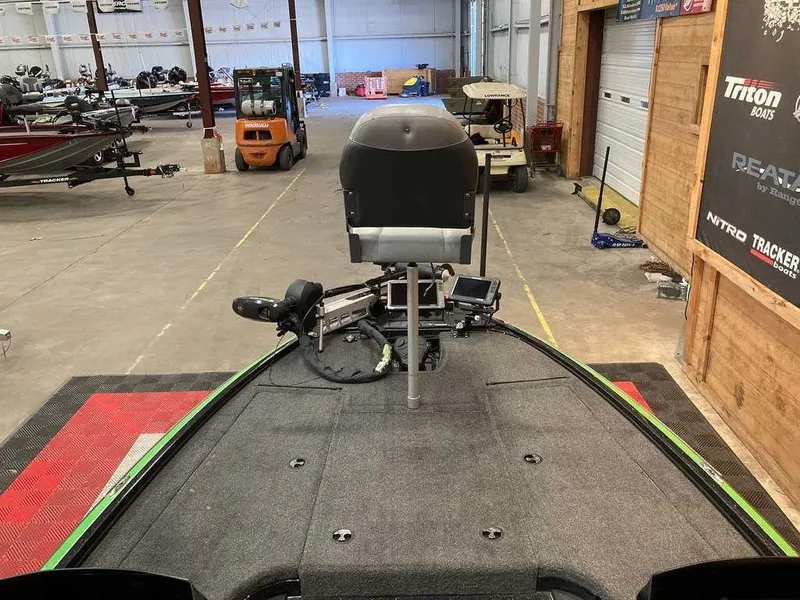 Slide: The Image of 2017 Nitro Z19 boat in a warehouse, featuring a fishing seat and equipment. - 8