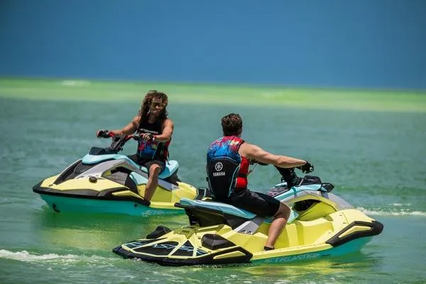 Slide: The Image of Two people riding 2025 Yamaha WaveRunner JetBlaster PRO 2-Up on vibrant blue water. - 9