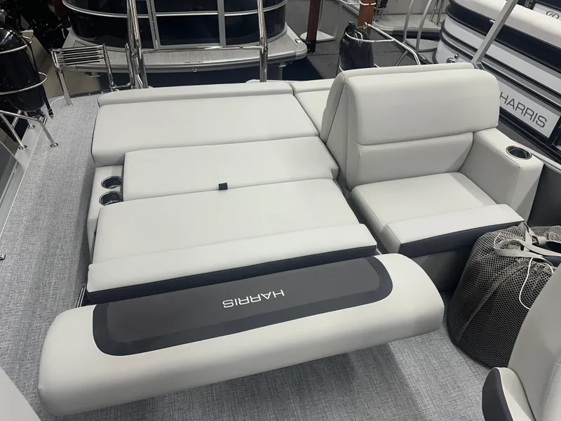 Slide: The Image of 2025 Harris Cruiser 230 boat interior with luxurious white seating and cup holders. - 11