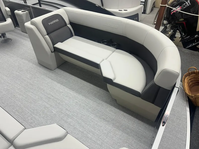 Slide: The Image of 2025 Harris Cruiser 230 boat interior with gray seating and carpet flooring. - 3