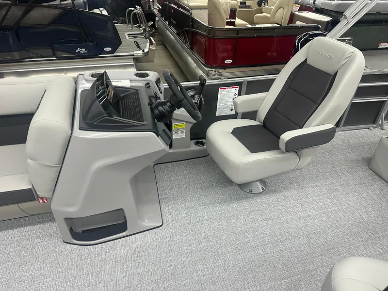Slide: The Image of 2025 Harris Cruiser 230 boat interior with modern helm and comfortable seating. - 5
