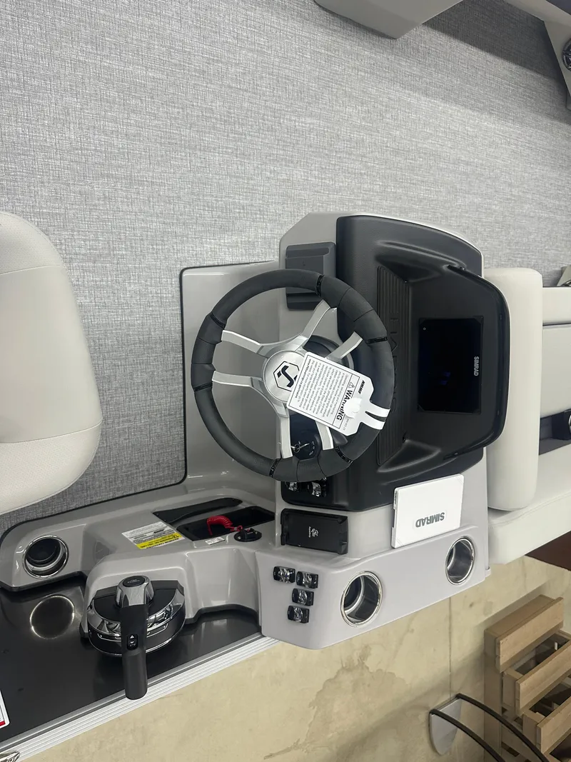 Slide: The Image of 2025 Harris Cruiser 230 boat dashboard with steering wheel and controls. - 6