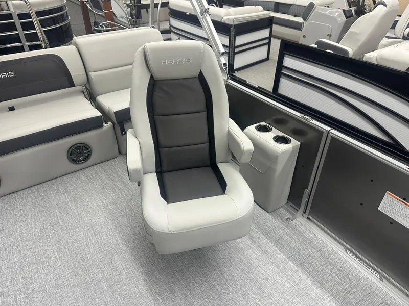 Slide: The Image of 2025 Harris Cruiser 230 boat interior with a comfortable captain's chair and cup holders. - 8