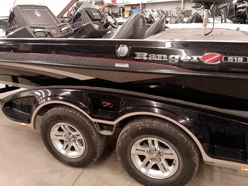 Slide: The Image of 2019 Ranger Z519 DC boat with dual axle trailer in a showroom. - 10