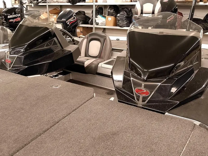 Slide: The Image of 2019 Ranger Z519 DC boat interior with dual consoles and seating in a showroom. - 11
