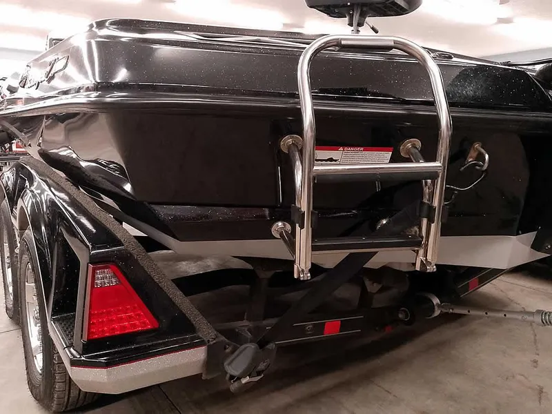 Slide: The Image of 2019 Ranger Z519 DC boat rear view with ladder and trailer. - 12