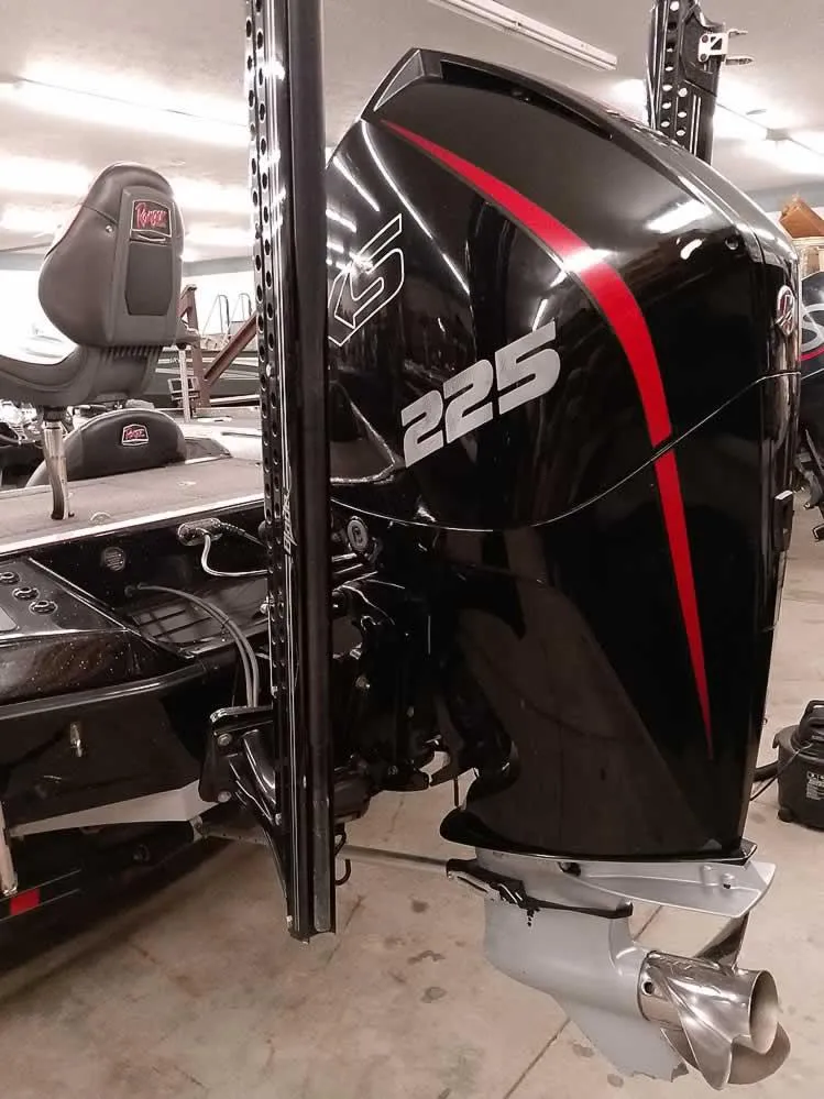 Slide: The Image of 2019 Ranger Z519 DC boat with a powerful 225 HP engine in a garage setting. - 13