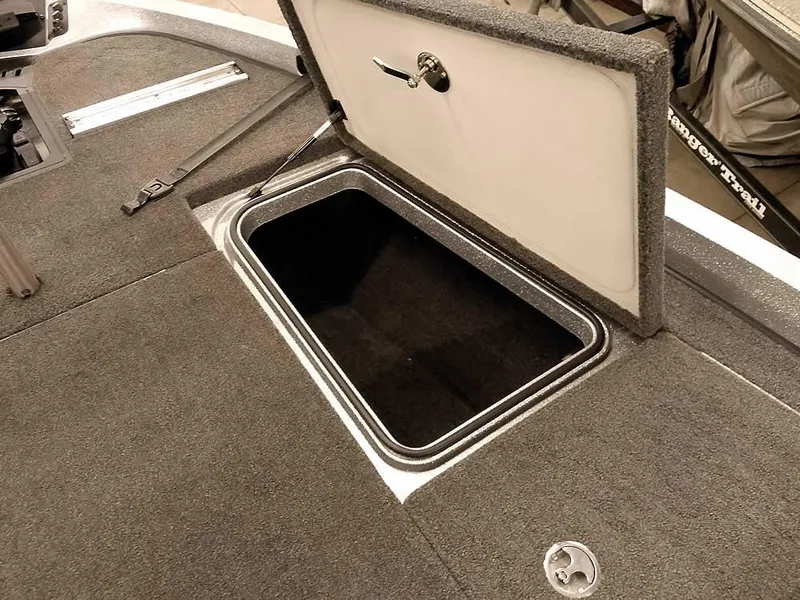 Slide: The Image of 2019 Ranger Z519 DC boat storage compartment with open lid, showcasing interior space. - 19