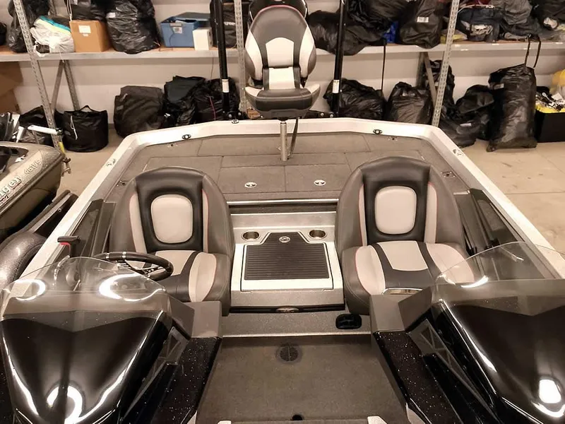 Slide: The Image of 2019 Ranger Z519 DC boat interior with dual consoles and seating in a storage area. - 24