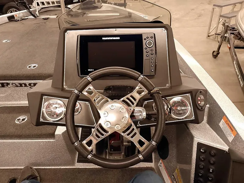 Slide: The Image of 2019 Ranger Z519 DC boat dashboard with steering wheel and electronic display. - 32