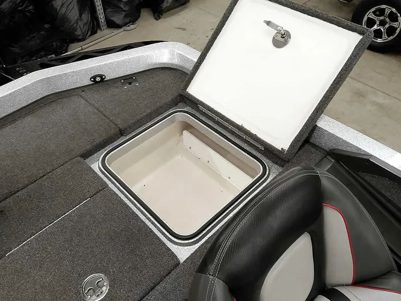 Slide: The Image of 2019 Ranger Z519 DC boat storage compartment with open lid, showcasing interior space. - 35