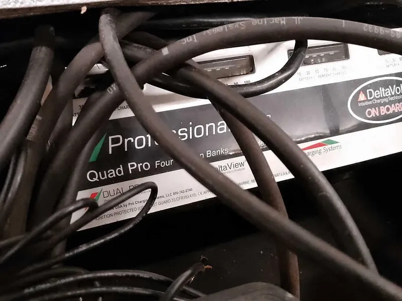 Slide: The Image of Tangled cables over a DeltaVolt Quad Pro charging system in a 2019 Ranger Z519 DC. - 39