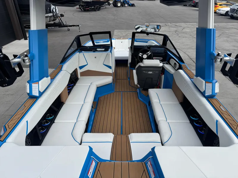 Slide: The Image of 2025 Nautique Super Air Nautique S23 interior with blue and white seating, spacious layout. - 15