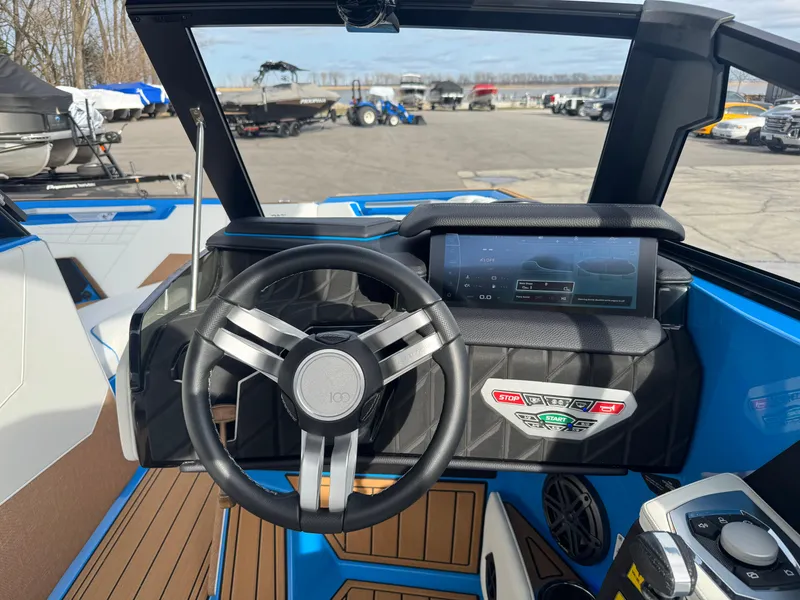 Slide: The Image of 2025 Nautique Super Air Nautique S23 dashboard with steering wheel and touchscreen display. - 25