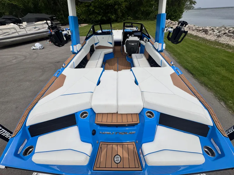 Slide: The Image of 2025 Nautique Super Air Nautique S23 boat with spacious seating and modern design. - 6