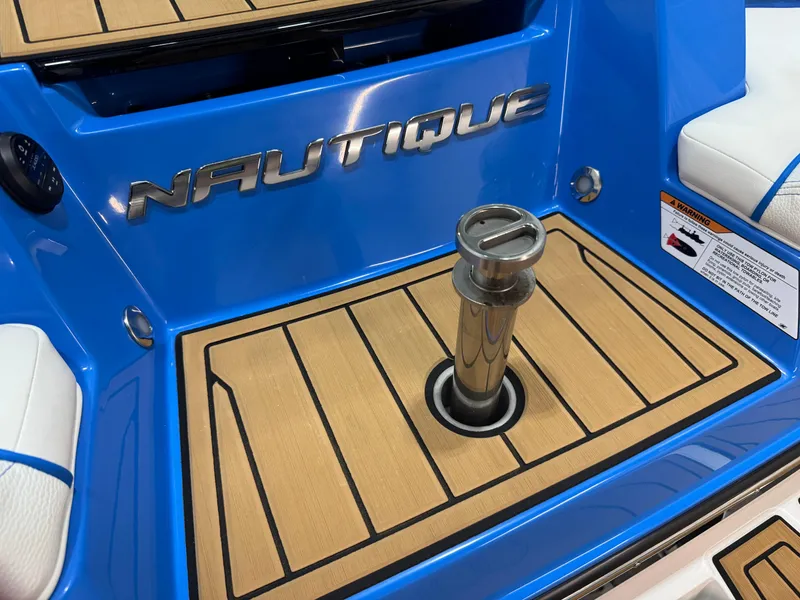 Slide: The Image of 2025 Nautique Super Air Nautique S23 boat deck with blue and wood accents. - 7