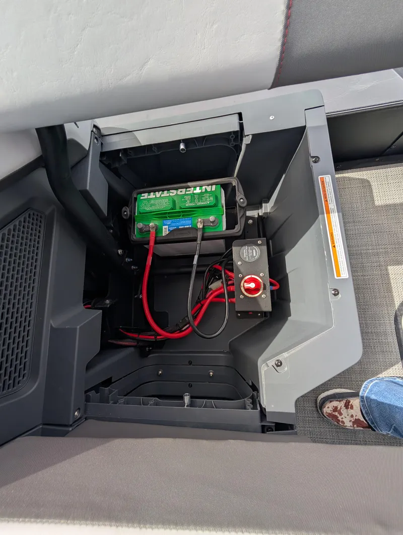 Slide: The Image of Battery compartment of 2025 Manitou Cruise boat, featuring wiring and control switch. - 22