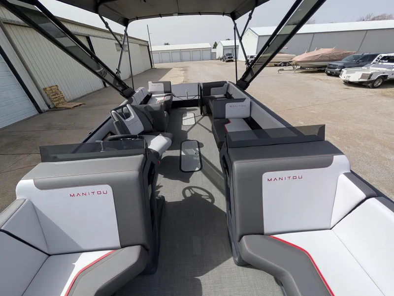 Slide: The Image of 2025 Manitou Cruise pontoon boat interior with spacious seating and modern design. - 44
