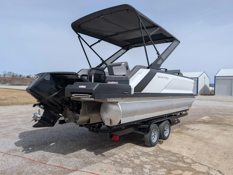 Slide: The Image of 2025 Manitou Cruise pontoon boat on trailer, featuring sleek design and modern amenities. - 6