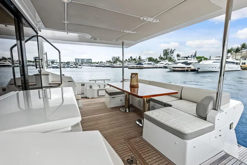 Slide: The Image of Luxurious 2017 Azimut 72 Flybridge yacht with elegant outdoor seating and scenic marina view. - 13