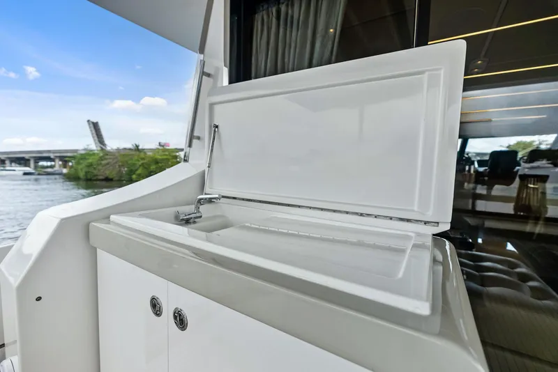 Slide: The Image of Outdoor sink on 2017 Azimut 72 Flybridge yacht, with scenic waterway view. - 16