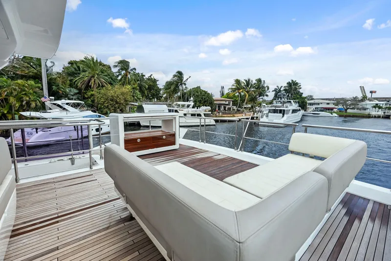Slide: The Image of Azimut 72 Flybridge 2017 yacht deck with luxurious seating and scenic waterfront view. - 23