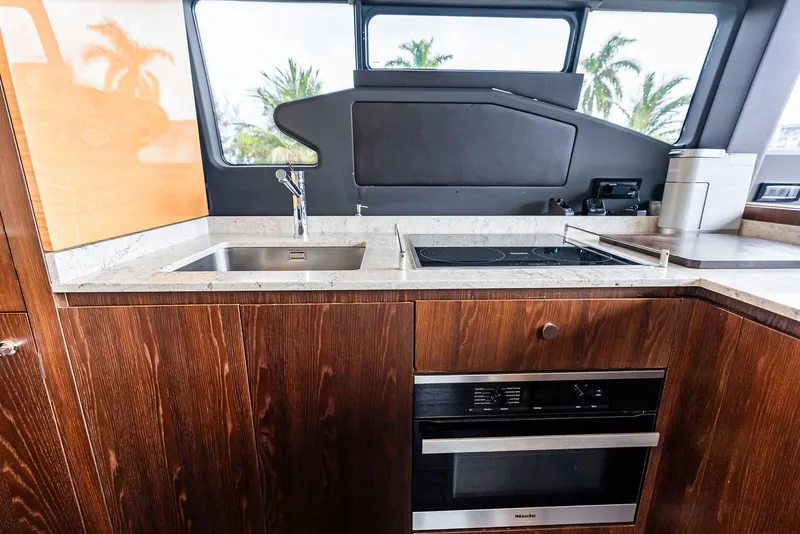 Slide: The Image of Modern kitchen interior of 2017 Azimut 72 Flybridge yacht with wood cabinetry and appliances. - 34