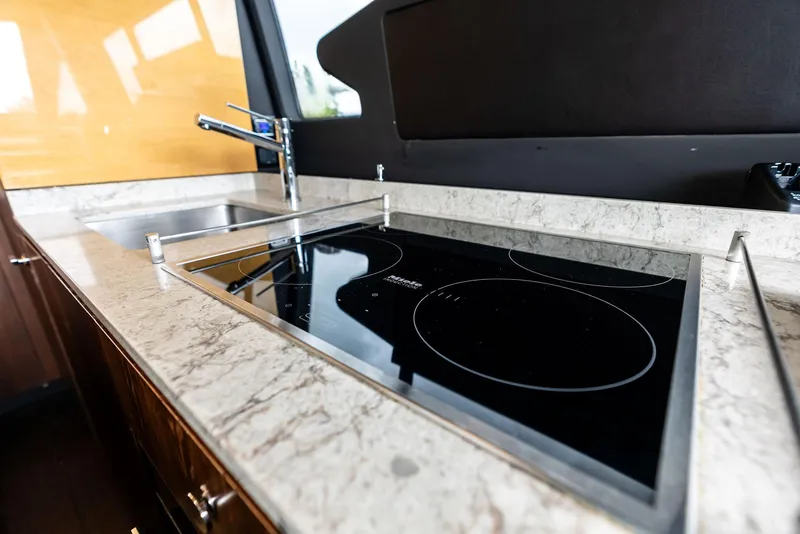 Slide: The Image of Modern kitchen in 2017 Azimut 72 Flybridge yacht with sleek stovetop and sink. - 35